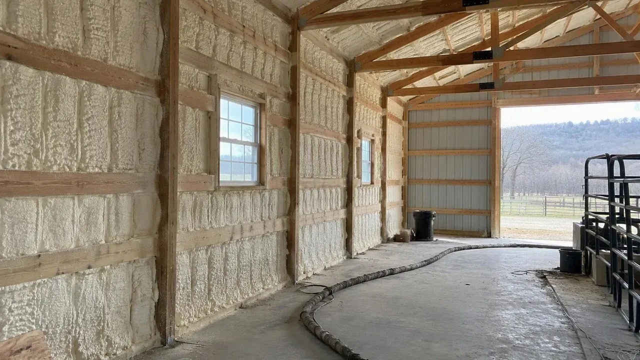 Rural barn interior during spray foam insulation