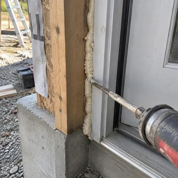 Sealant closing a gap beside an exterior door frame