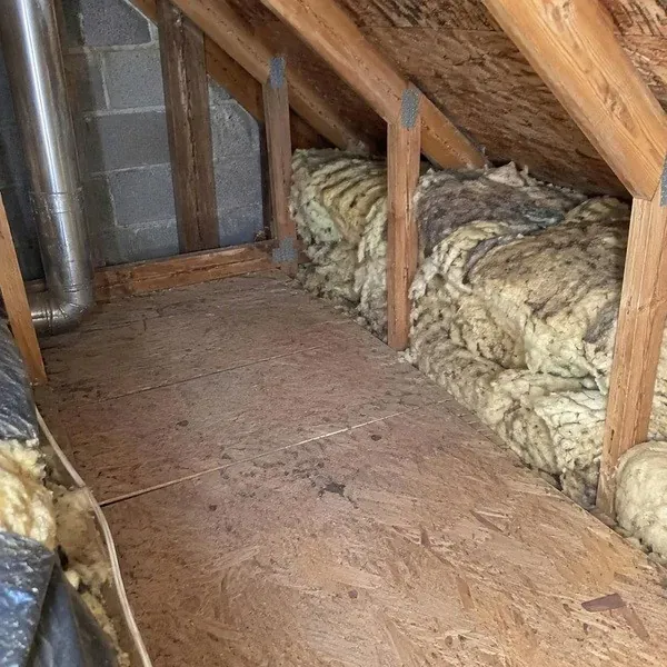 Attic partly cleared of old insulation during insulation removal