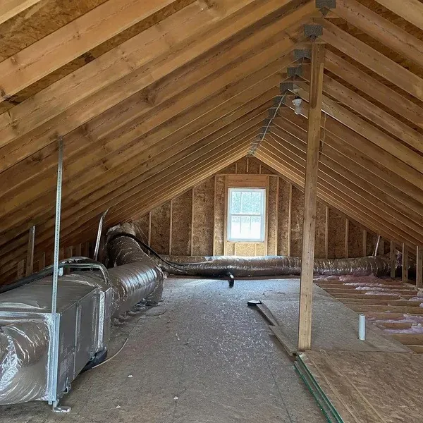 Bare attic rafters and roof sheathing before spray foam insulation