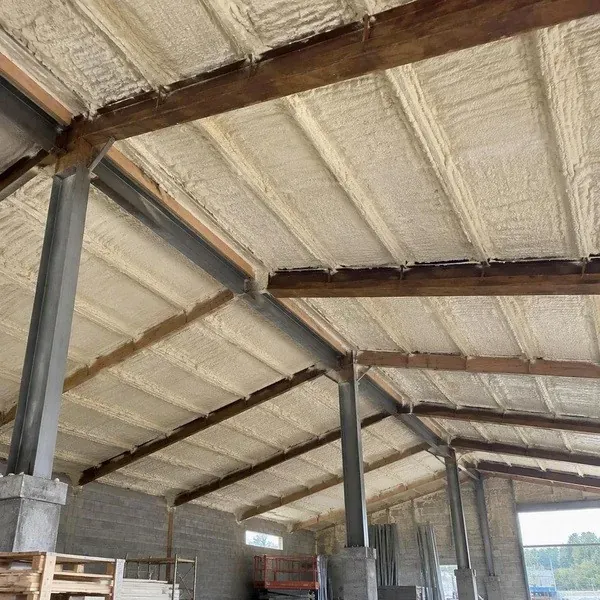Factory roof underside covered with closed cell spray foam