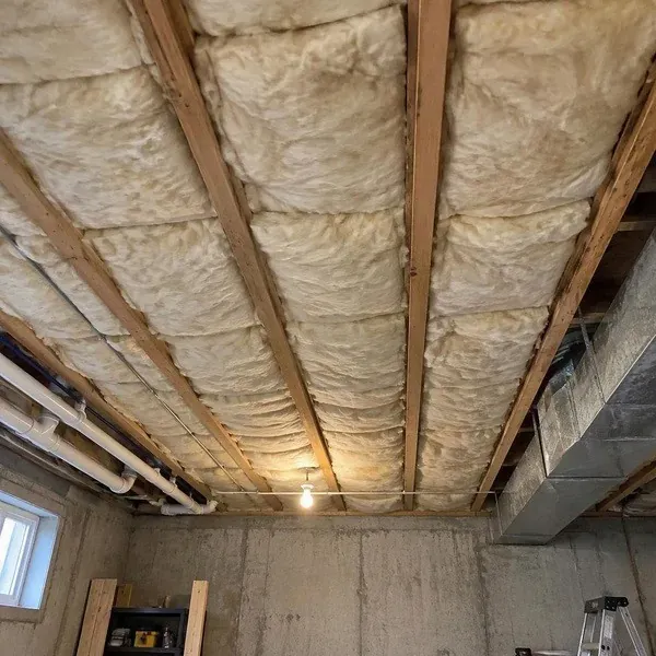 Fiberglass batt insulation fitted between exposed ceiling joists