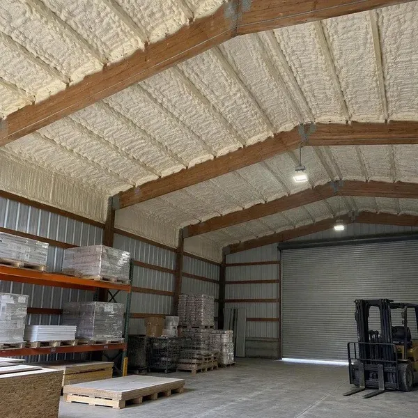 Spray foam insulated roof over an industrial storage bay