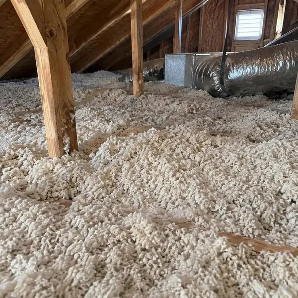 Loose fill insulation covering an unfinished attic floor
