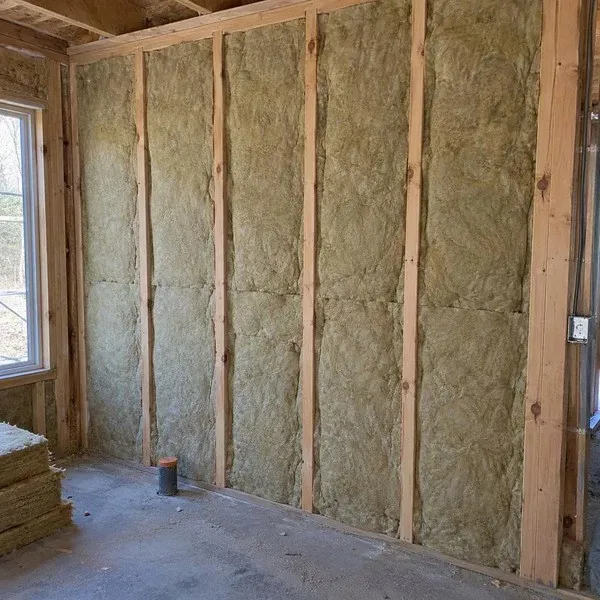 Mineral wool batts fitted between wall studs