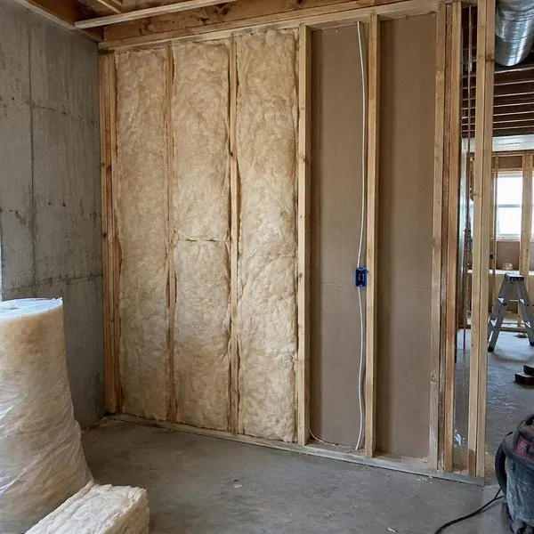 Partly insulated wall with empty stud cavities still to fill