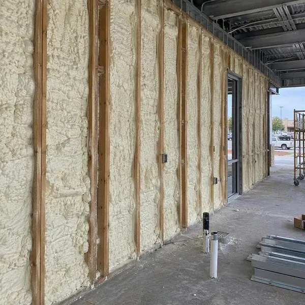 Spray foam insulating the exterior walls of a retail unit