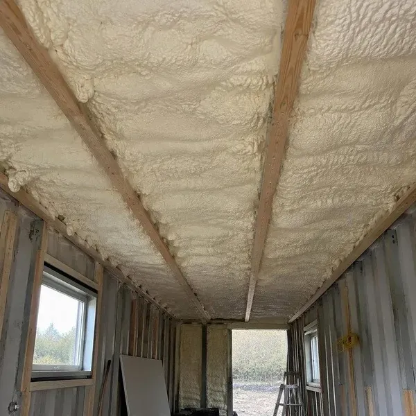 Spray foam insulation on a converted shipping container ceiling