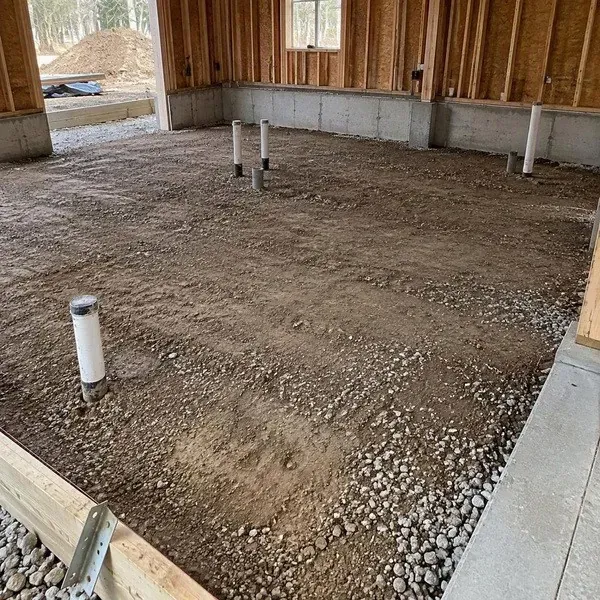 Compacted gravel base with plumbing ready for underslab spray foam