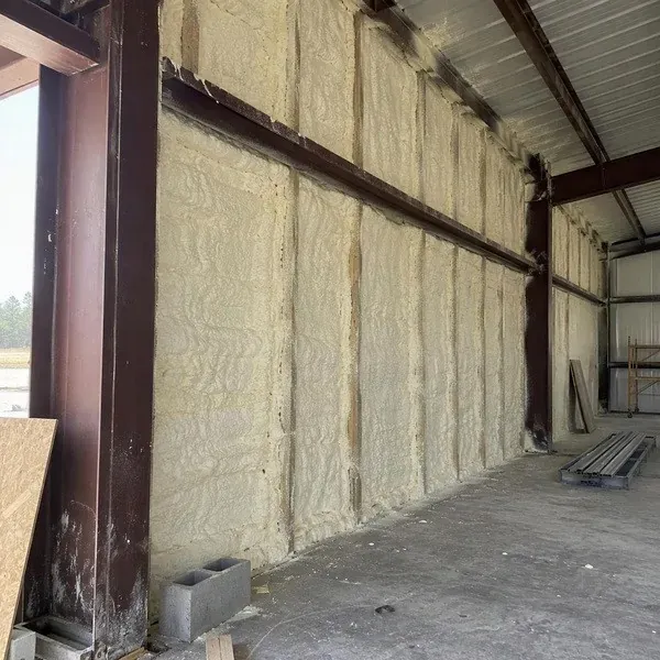 Spray foam around warehouse structural steel framing